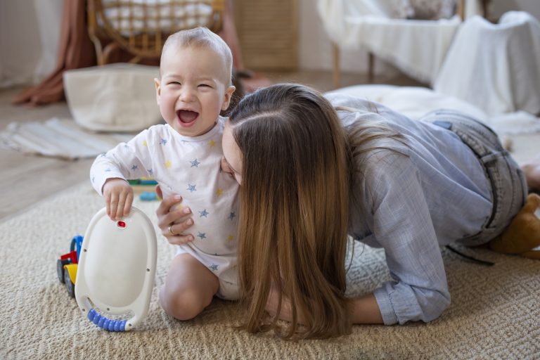 full shot mother playing with baby