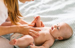 mom doing baby massage mobile